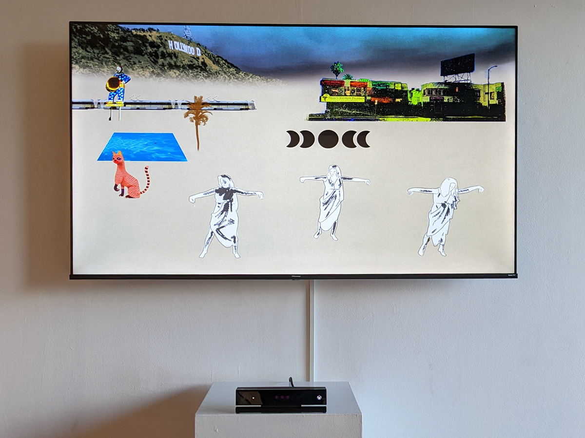 A second configuration of the same installation showing a Hollywood scene with three tracked figures standing with arms outstretched, above a depth sensor on a white plinth.